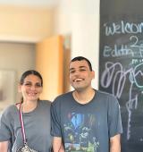 Roberto (right) stands smiling with his mother, Veronica