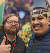 Orlando, right, stands with a staffer at comic con NYC