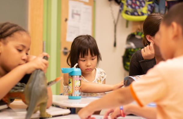 students of Manhattan Star Academy are deeply engaged in tasks at a tablell