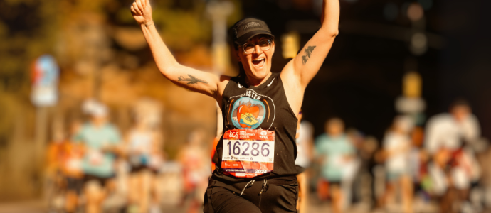 Kristen runs the 2024 NYC marathon, she has her hands in the air and is cheering