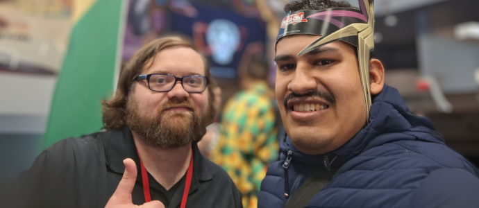 Orlando, right, stands with a staffer at comic con NYC