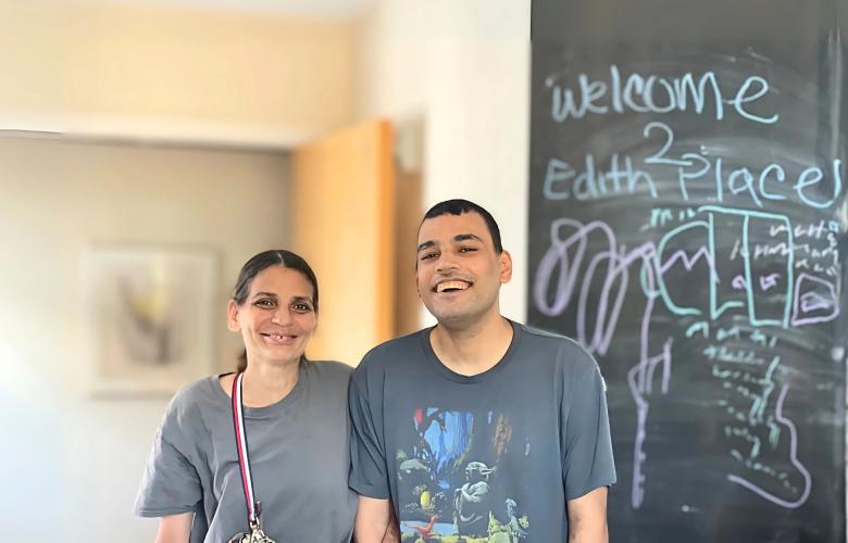 Roberto (right) stands smiling with his mother, Veronica