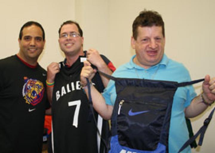 Franco Pacific (left), distributes Nike gear at the Long Island Employment Training Program.