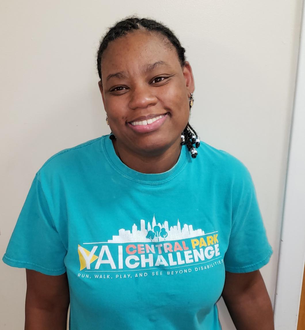 Headshot of Natasha smiling. She's wearing a Central Park Challenge shirt.