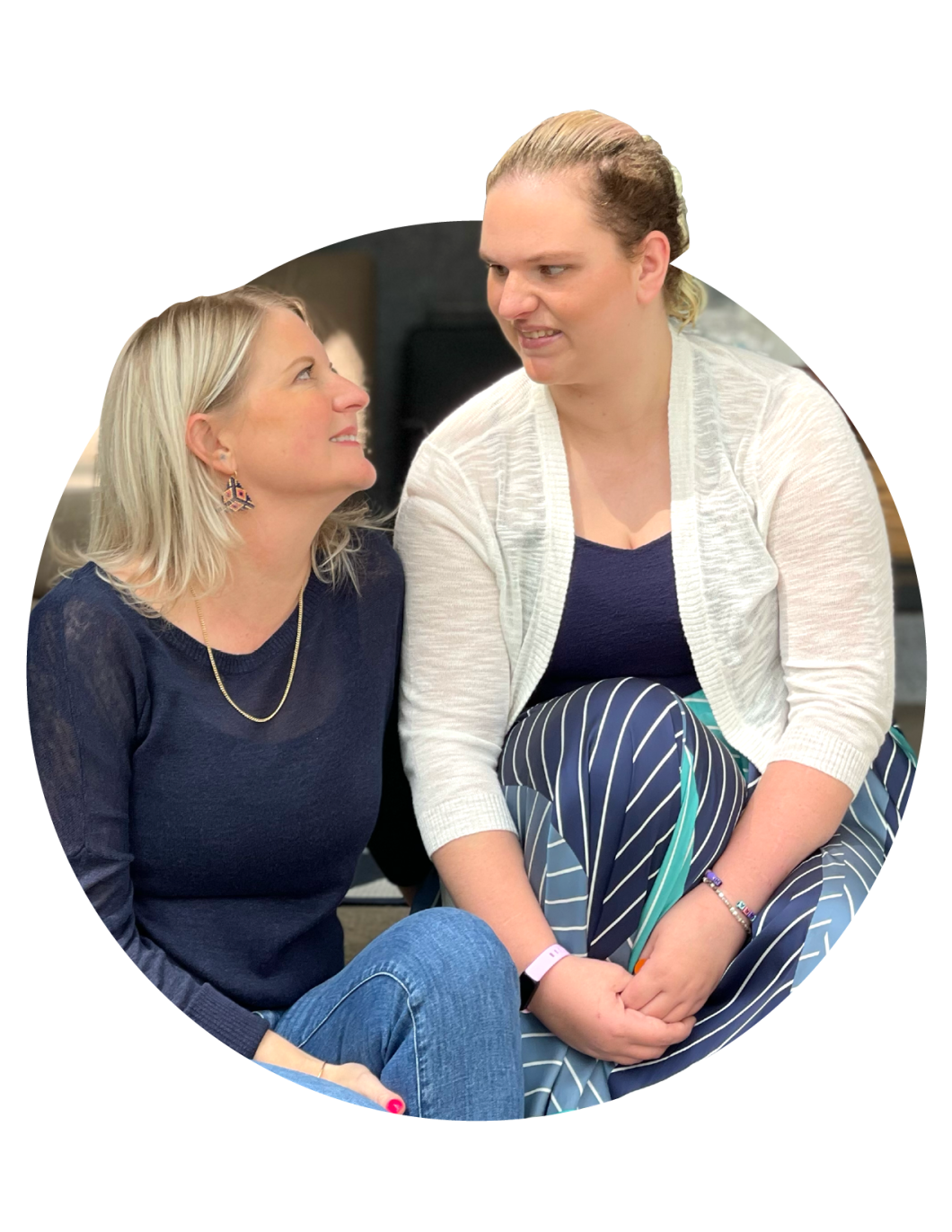 Diane crouches next to and looks up to her daughter, Sarah