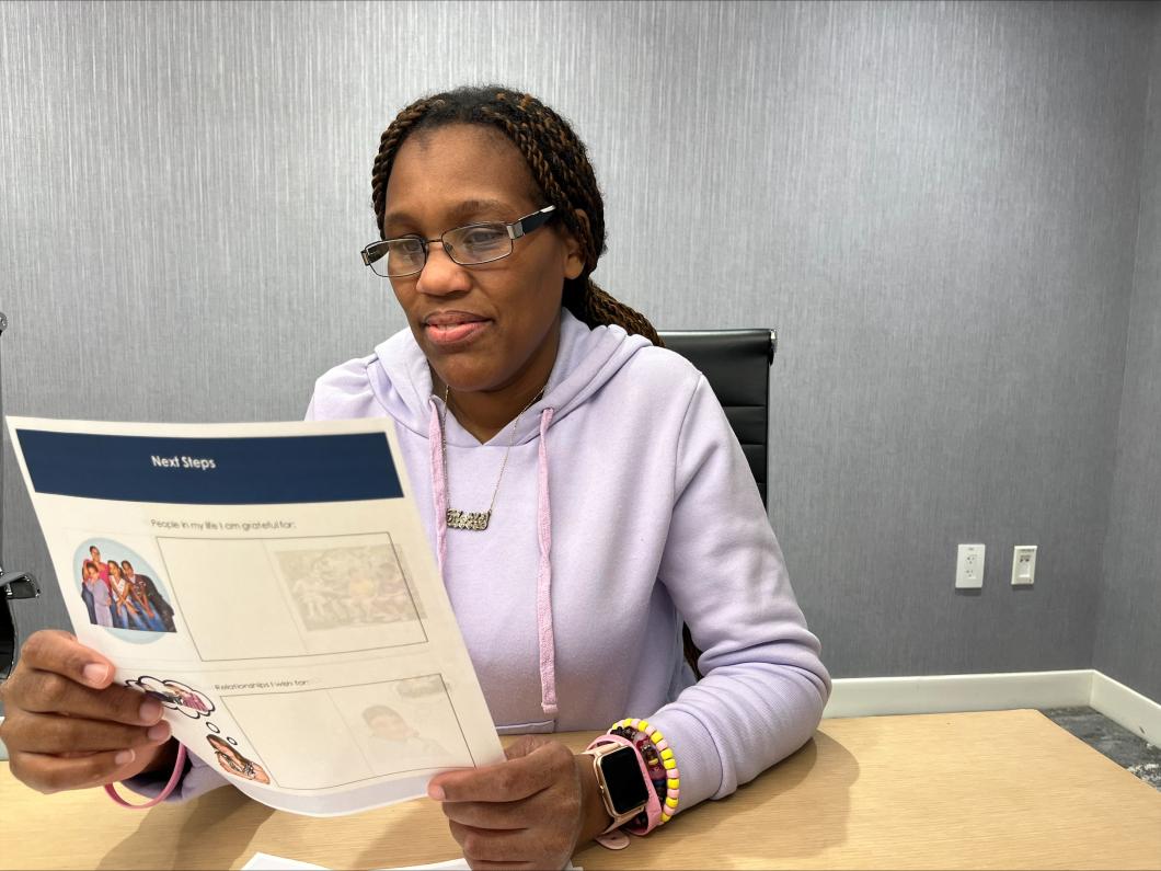 Woman reading an Easy Read document from ReadAble at YAI