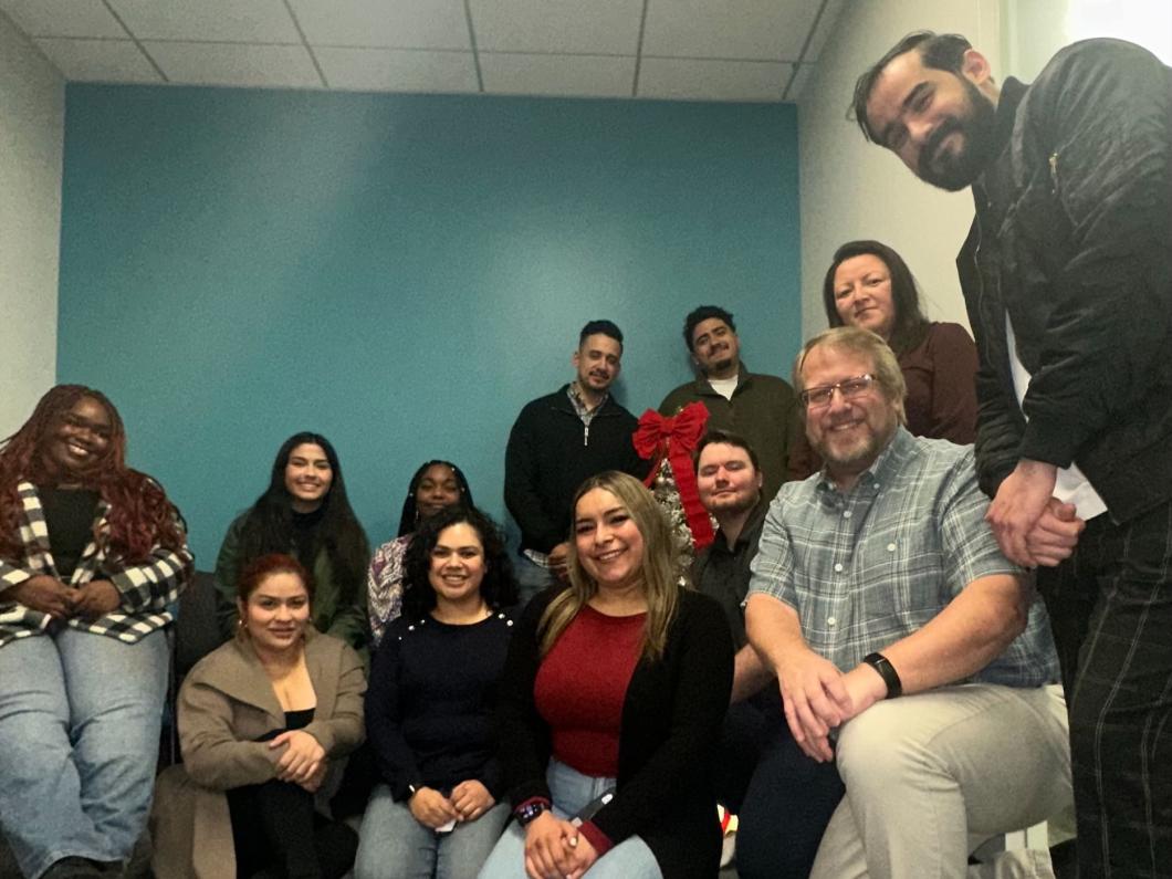 Group of 12 people pose for a photo