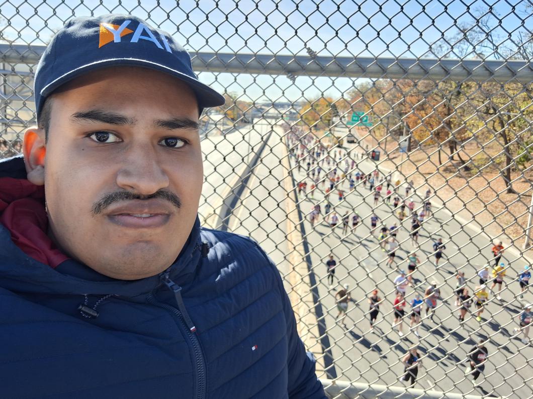 Orlando is above many runners on the road below the bridge he's standing on